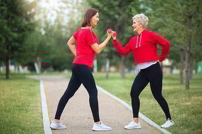 two-beautiful-adult-women-doing-sports-dumbbells